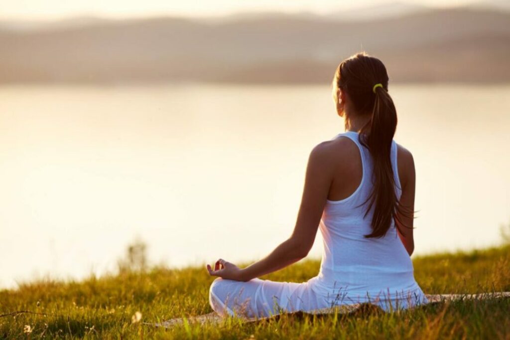 Ilustramos uma mulher fazendo meditação para tratar sua depressão